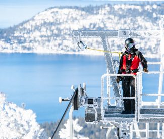 female ski patroller on lift tower