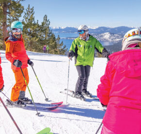instructor on crystal ridge with lake tahoe in background teaches ski clinic