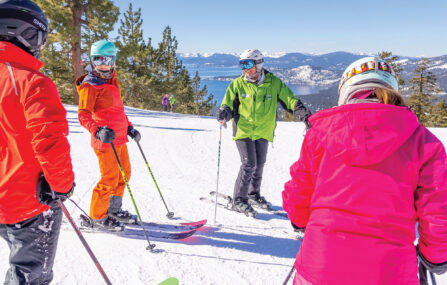 instructor on crystal ridge with lake tahoe in background teaches ski clinic