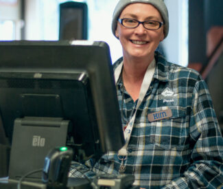 diamond peak female employee pose in food court at register