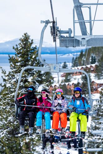 asian family on lakeview chairlift with lake tahoe views