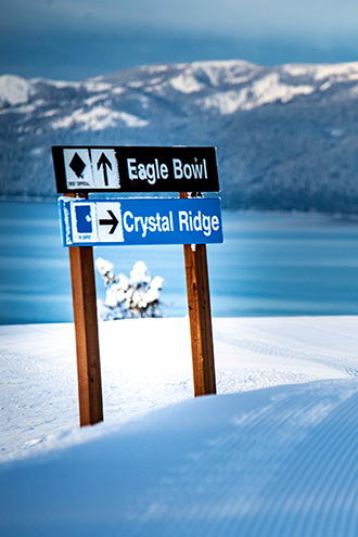 trail signs for eagle bowl and crystal ridge with views of lake tahoe