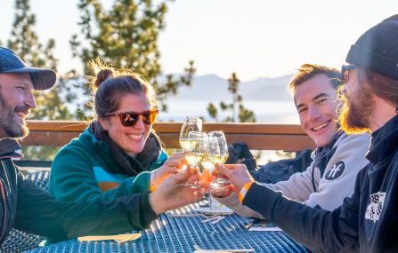 last tracks event group cheers wine glass with lake tahoe views