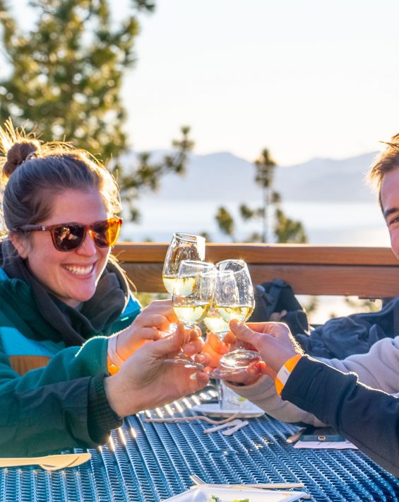 last tracks event group cheers wine glass with lake tahoe views