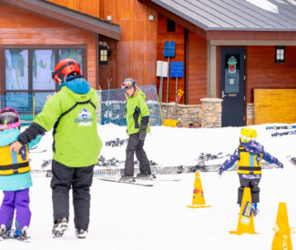 instructors with kids in ski school