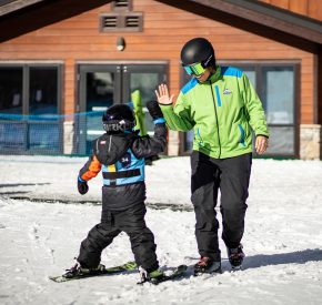 instructor gives high five to kid