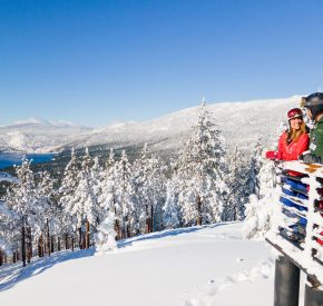 couple on snowflake lodge deck view lake tahoe views