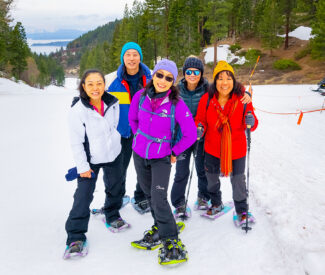 group of snowshoe hikers smiling