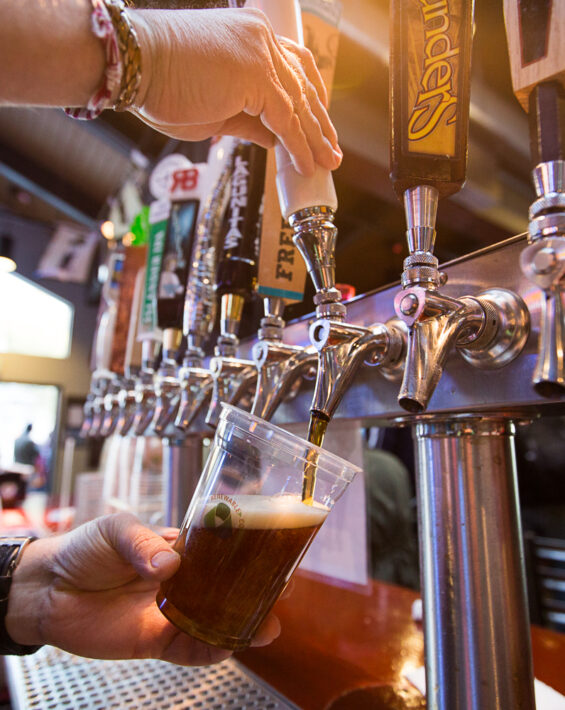 bartender pours draft beer at diamond peak loft bar