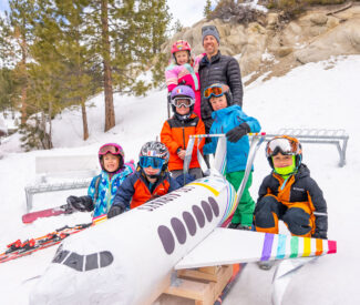 lake tahoe school kids pose by airplane dummy at diamond peak