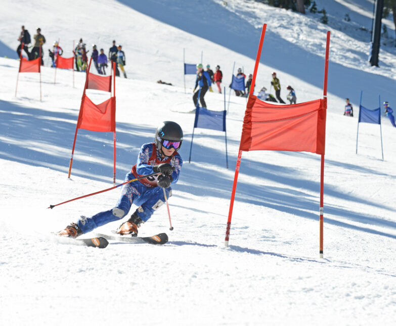 ski racer skiing around red race gate