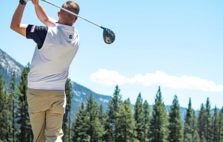 male golfer swings on driving range at Incline village championship golf course