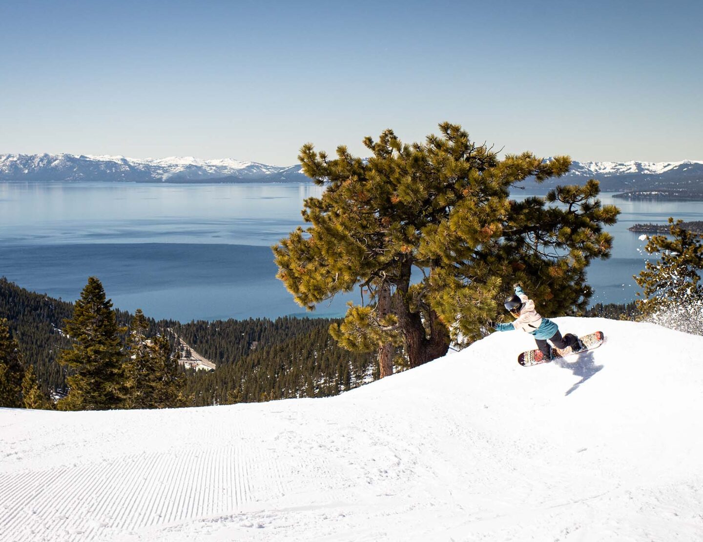 Snowboarder on Crystal Ridge with Lake Tahoe view