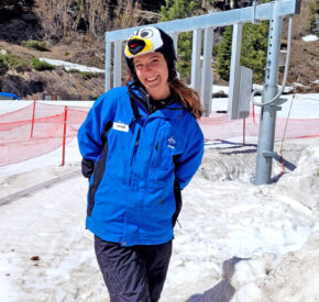 female lift operator with penguin hat in front of new gates at crystal chair