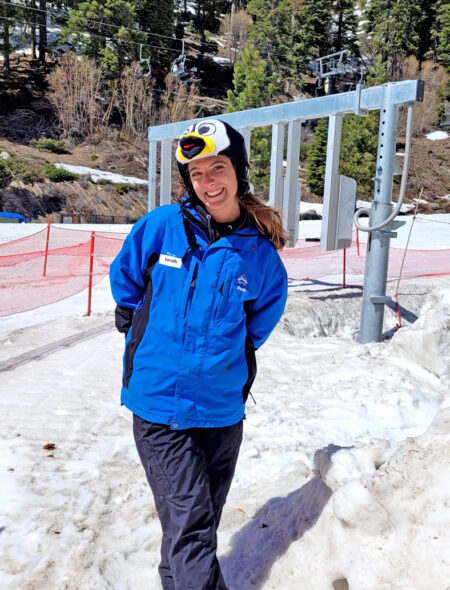 female lift operator with penguin hat in front of new gates at crystal chair