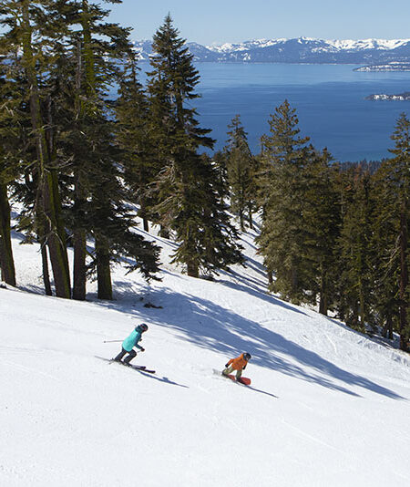 Skier and snowboarder on Diamondback run at Diamond Peak