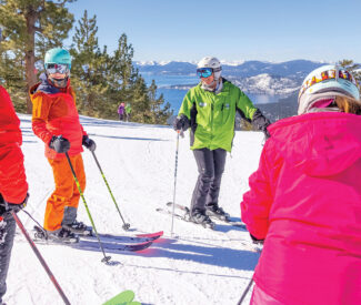 instructor on crystal ridge with lake tahoe in background teaches ski clinic
