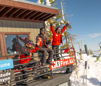 ski patrollers posing at ski patrol shack
