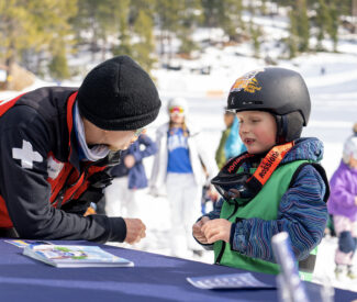 ski patroller talking to a child