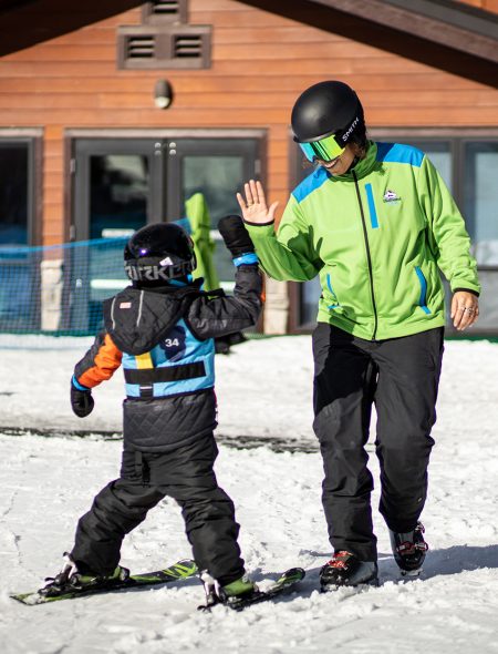 instructor gives high five to kid