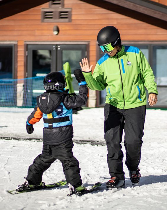 instructor gives high five to kid