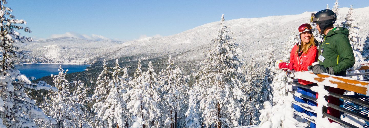 couple on snowflake lodge deck view lake tahoe views
