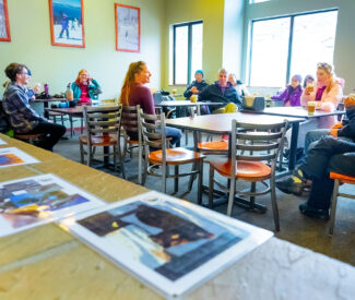 group listen to naturalist in fireside room