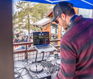dj under tent on diamond peak deck