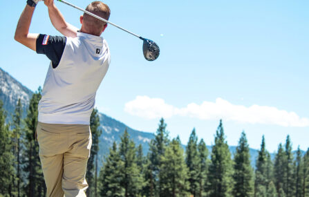 male golfer swings on driving range at Incline village championship golf course