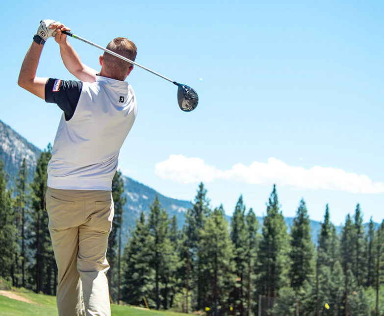 male golfer swings on driving range at Incline village championship golf course