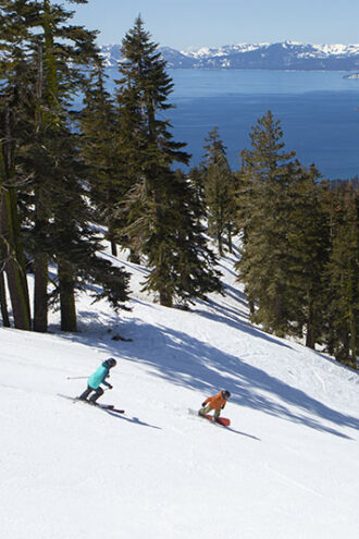 Skier and snowboarder on Diamondback run at Diamond Peak