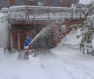 employee with snow blower