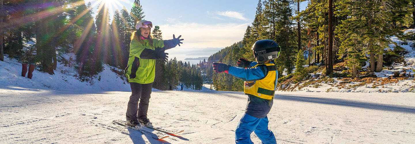 child in ski lesson with instructor