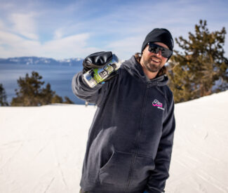 Man holding Alibi beer on a run at Diamond Peak
