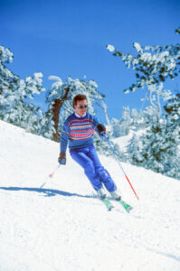 retro guy skiing in a sweater