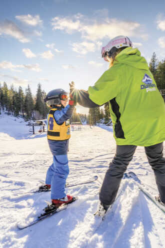 child ski lesson high five